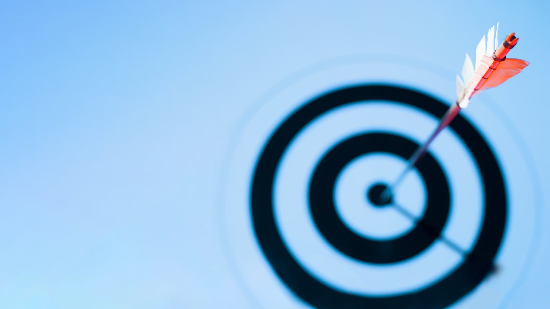 Close-up of arrow in bulls eye of target